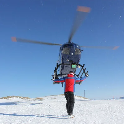 helicopter landing on a ski slope